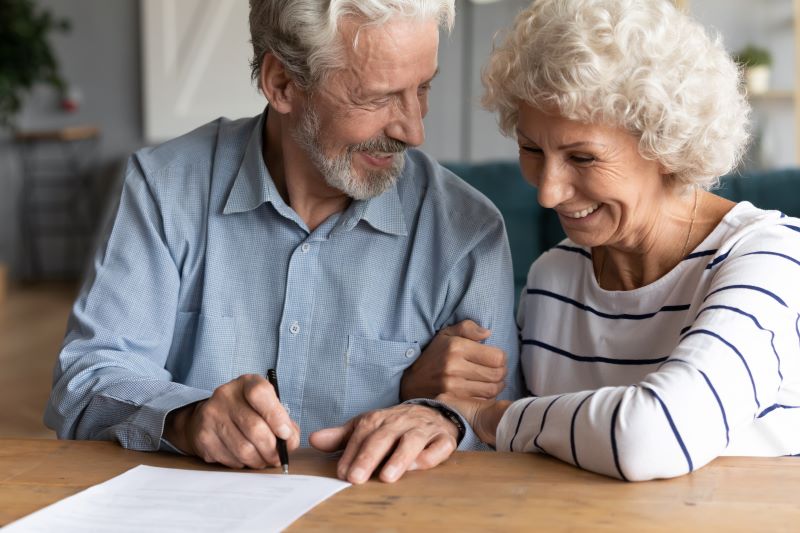 Happy senior older married couple discussing investing saving